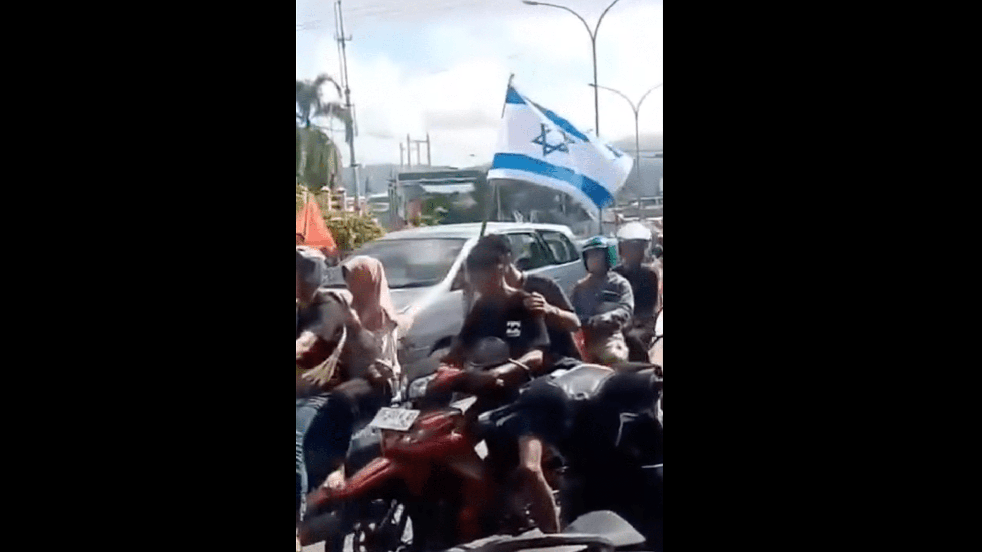 Brazil supporters in Indonesia grab Israeli flag off motorcyclist