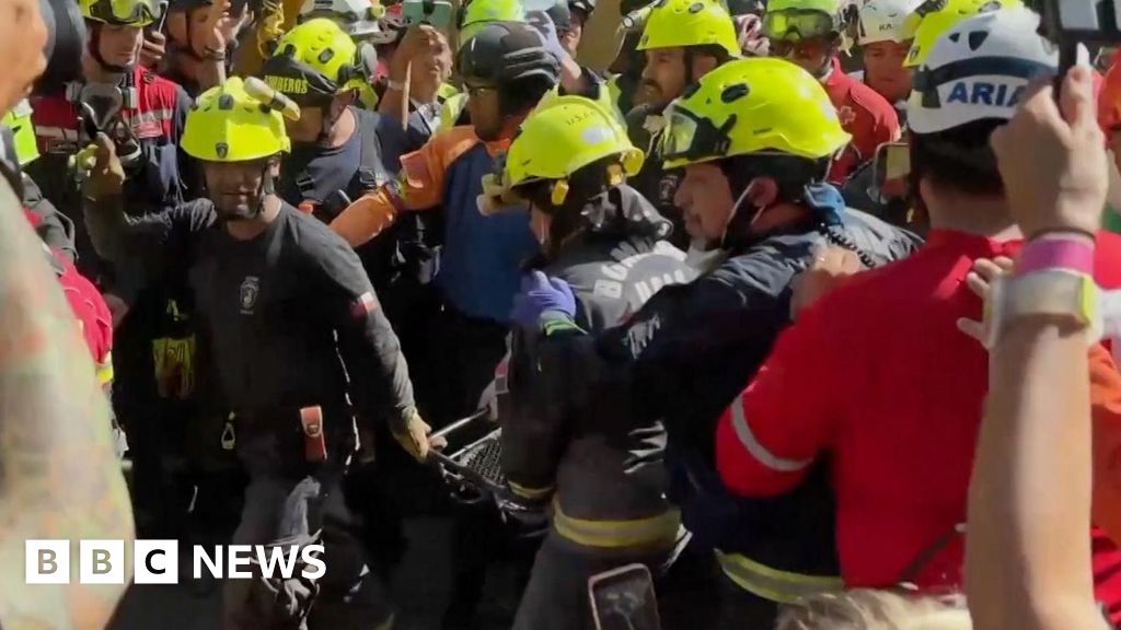 Cheers and applause as security guard rescued from rubble