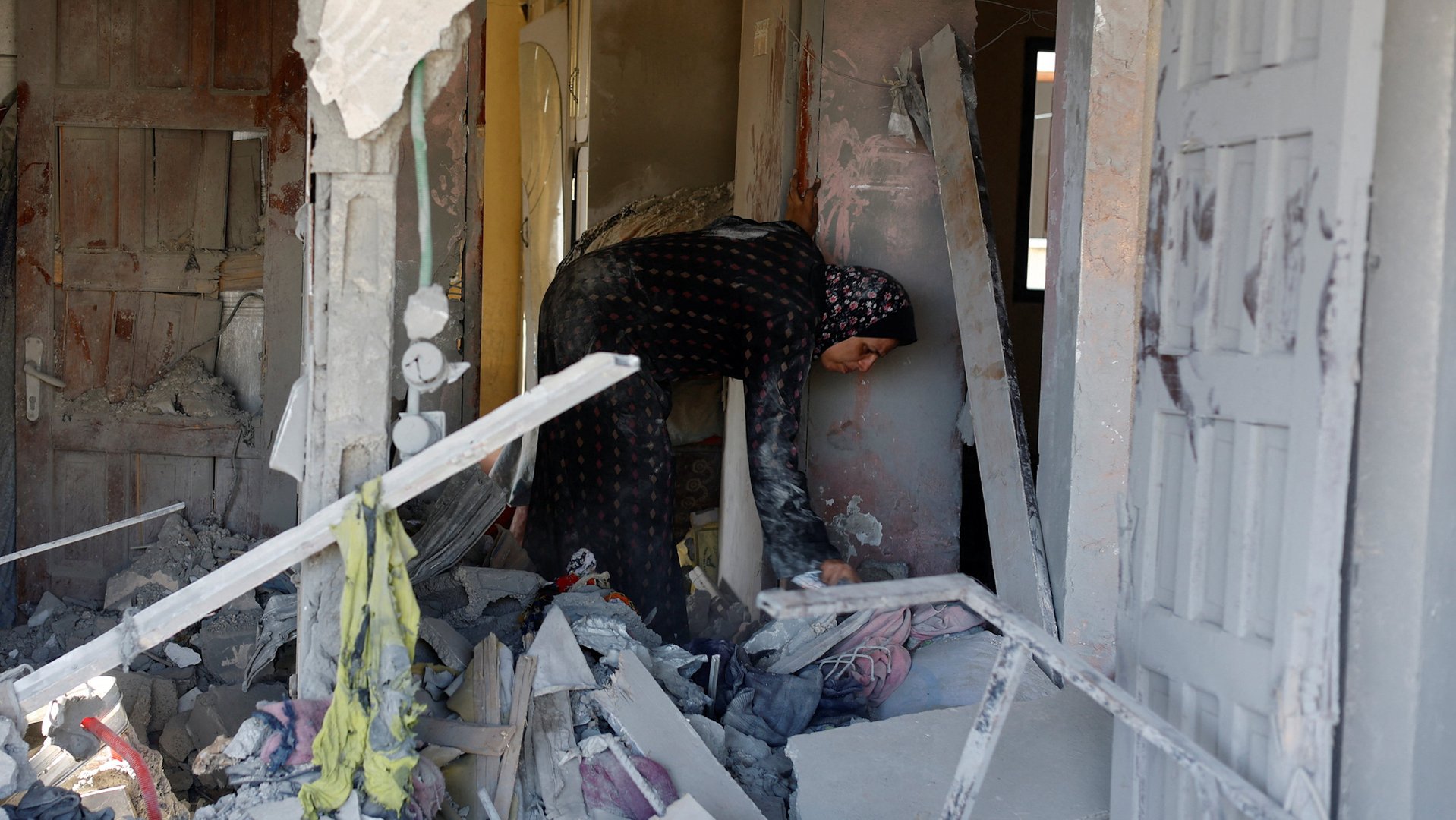 Palestinians in Gaza search through homes destroyed by Israeli strikes