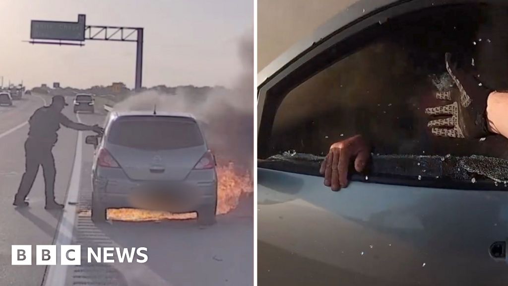 Watch: US police officer pulls man from burning car