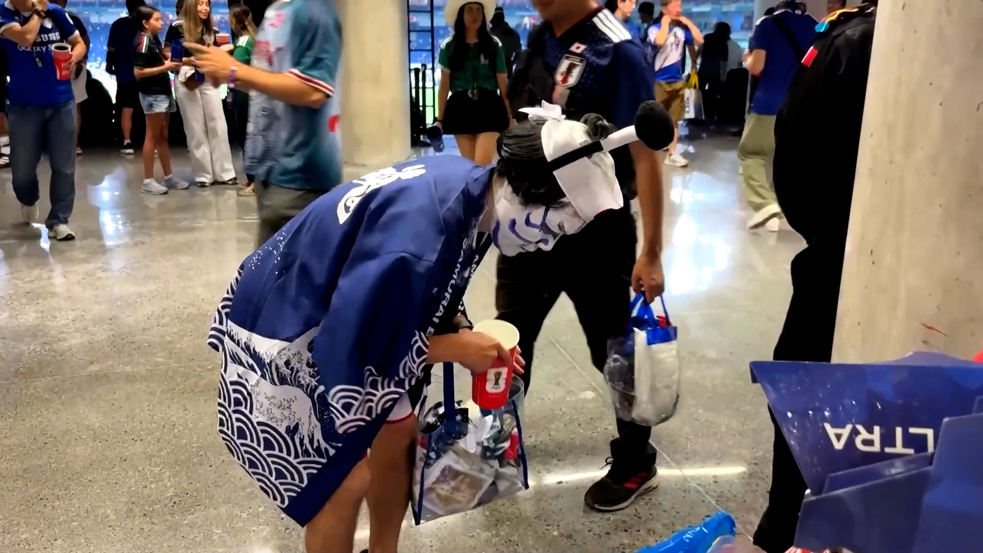 Japanese fans clean up stands after celebrating World Cup win