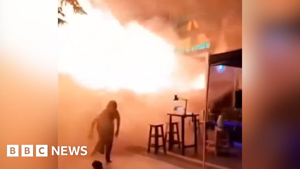 People flee Bangkok bar as huge flames shoot out from doorway